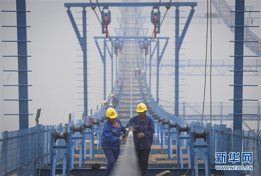 (圖文互動)(1)武漢楊泗港長江大橋首根主纜索股完成安裝